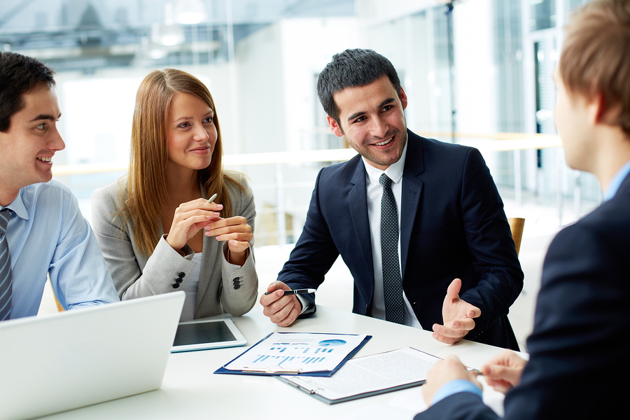 Image of business partners discussing documents and ideas at meeting